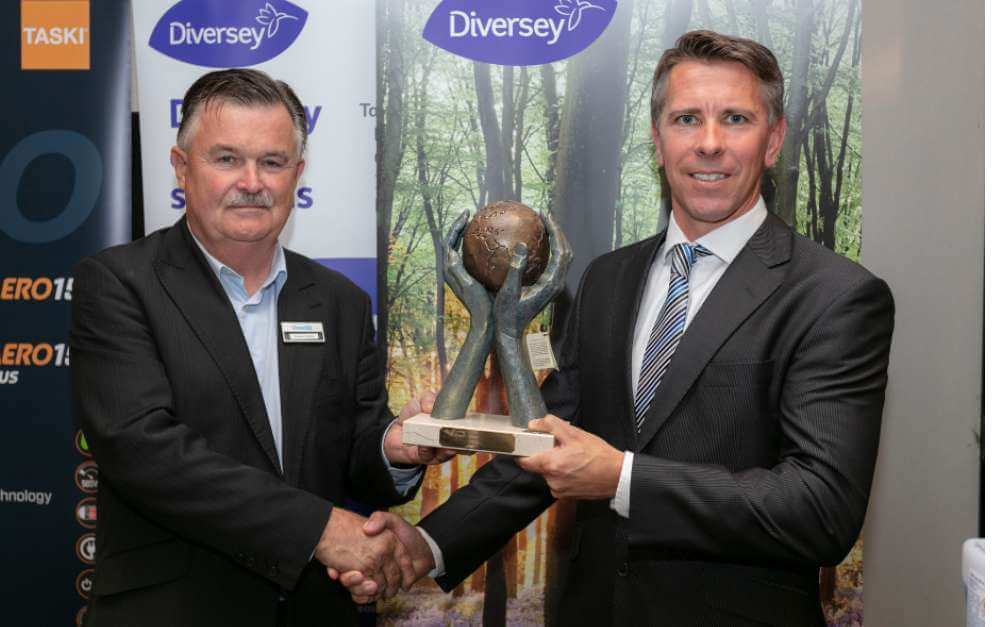 Gerard McCarthy, Derrycourt Operations Manager (on right) smiles as he accepts the Sustainability Award at ICCA Elevate from Eugene Grogan